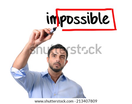 young handsome business man turning impossible word into possible with red marker writing on glass isolated on white background in motivation,  incentive and challenge concept