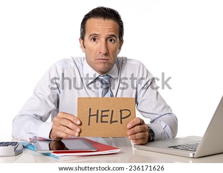 desperate senior businessman in crisis working on computer laptop at office desk in stress under pressure facing work problems asking for help isolated on white background