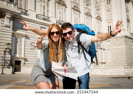 young beautiful friends tourist couple visiting Madrid - Spain on holidays exchange students posing together in town happy with city map on sunny day in travel and vacation concept