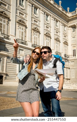 young beautiful friends tourist couple on holidays exchange students visiting Spanish town happy with city map on sunny day in travel and vacation concept