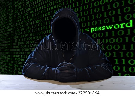 criminal or terrorist man in gloves, black hood and thief mask looking dangerous with hidden identity in secret illegal password violation and crime concept with creepy scary terrorist and maniac look