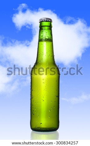 one Cold frosted beer bottle with frost and bubbles in green glass bottle isolated on a blue sky background in alcoholic refreshing drink concept