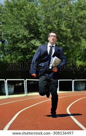 businessman in suit and necktie carrying folder portfolio and files running desperate in stress on athletic track looking tired and stressed in work urgent problems concept