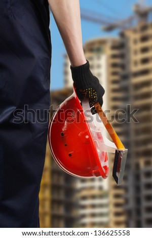 Construction hard hat in hand
