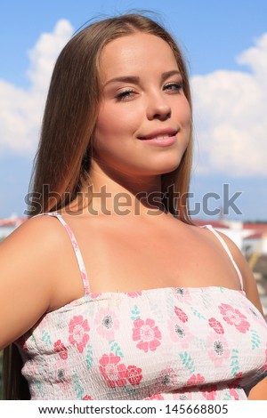 Thick Beautiful Teen Girl With Long Hair Against The Blue Sky With Clouds Thick Beautiful Teen Girl With Long Hair Against The Blue Sky With Clouds