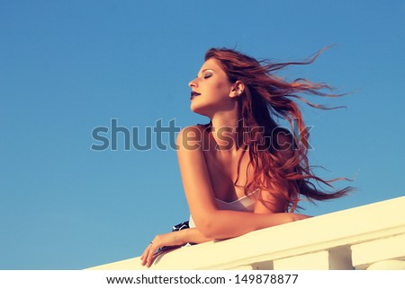 vintage. red-haired girl, hair developing on a wind. photo outdoors