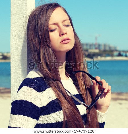 Fashionable girl photo. Marine style. Woman at the beach. Summer vacations concept. Photo toned style instagram filters