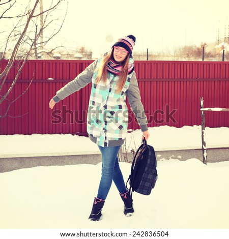 Portrait of Trendy Hipster Girl on Bright Winter Clothes, Traveler Woman with Backpacks. Freedom and Active Lifestyle Concept Photography toned style Instagram filters.