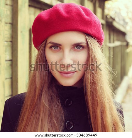Elegant young Parisian woman outdoors. Beautiful charming girl in red beret. French Style photo with instagram retro filters.