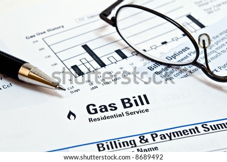 Natural gas heating bill with pen and glasses