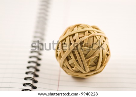 Rubber band ball on lined notebook paper with shallow depth of field