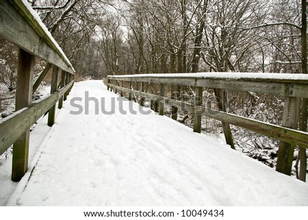 Winter snow scene of a fence and a snow covered path