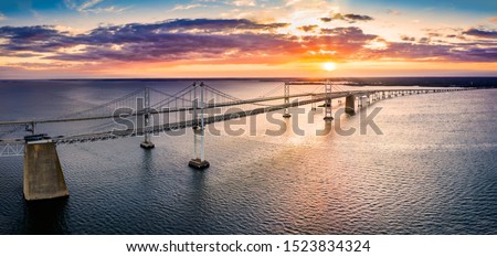 Aerial panorama of Chesapeake Bay Bridge at sunset. The Chesapeake Bay Bridge (known locally as the Bay Bridge) is a major dual-span bridge in the U.S. state of Maryland.