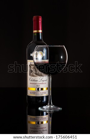 CHATHAM, NJ, UNITED STATES - FEBRUARY 8, 2014: Glass and Bottle of 2011 Chateau Lagnet wine. Chateau Lagnet is a red wine from Bordeaux, France made of 80% Merlot and 20% Cabernet Sauvignon.