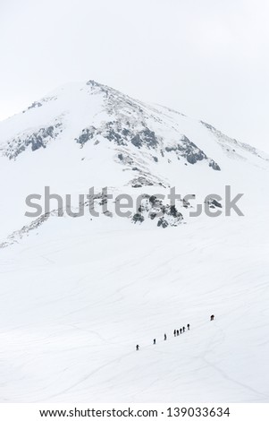 Group of hikers climbing a snow mountain