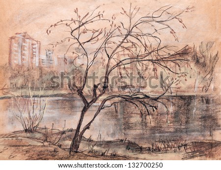 Autumn landscape with a tree, lake and city buildings in the distance