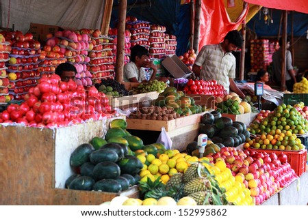 BANGALORE, INDIA - AUGUST 25: Unidentified street sellers with their fruits shop on a city street on August 25, 2013 in Madiwala market, Bangalore, Karnataka, India.