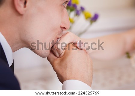 Groom kissing bride\'s hand