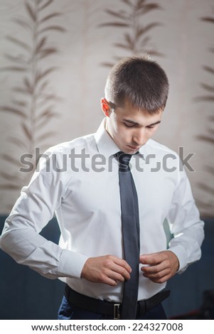 Man straightens his tie