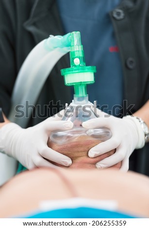 pre oxygenation chin lift position with two hand holding oxygen