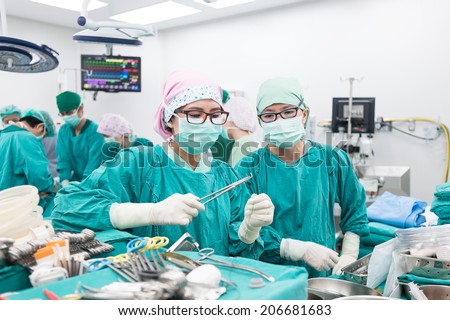 two scrub nurse preparing tools in critical situation