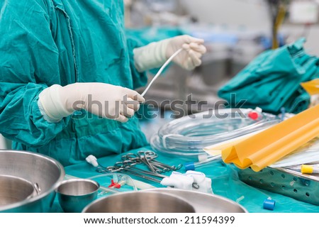 scrub nurse preparing tools for open heart surgery
