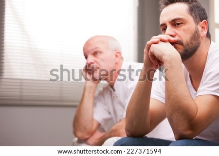 a couple of male friends thinking about something that worries them