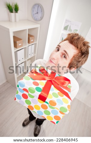 happy clerk with a big gift in wide-angle point of view