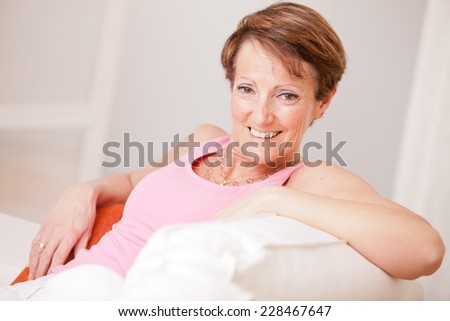 an old woman perfectly healthy and relaxed in a beautiful home in happiness and joy