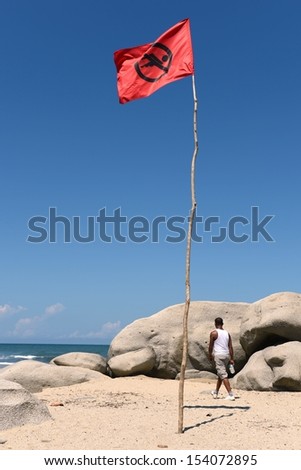 TAYRONA, COLOMBIA - NOVEMBER 13:  Tayrona National Park - a huge protected area of 12 000 hectares, on the Caribbean coast of Colombia. Red flag on the beach in November 13, 2012 in Colombia.