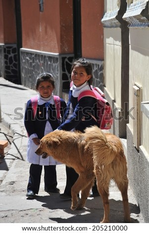 POTOSI, BOLIVIA - SEPTEMBER 8, 2010: Potosi  is one of  highest cities in  world. History City is closely connected with extraction of rich deposits of silver. Unidentified girls on  street of Potosi.