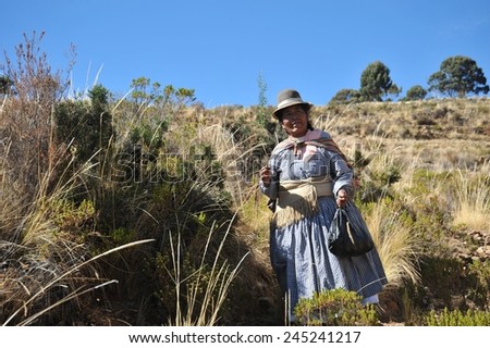 ISLAND OF THE MOON, BOLIVIA - SEPTEMBER 4, 2010 : Island of the Moon is located on lake Titicaca. Incas live here in seclusion. Unknown woman on the island of the Moon.