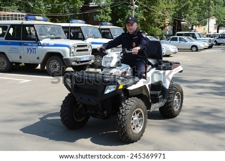 KHIMKI, RUSSIA - AUGUST 9, 2013: Police patrol the streets  in the suburban town of Khimki on the quadrocycle. Patrol and inspection service of the police provides public safety in the city.