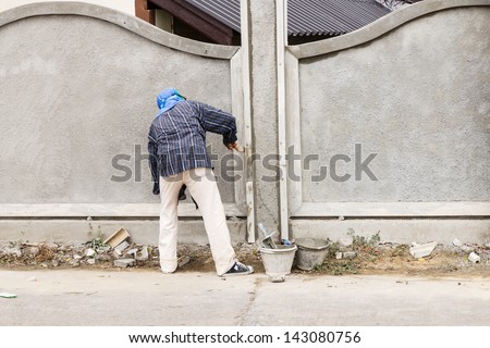 Man construction worker building wall home, tile floor adhesive