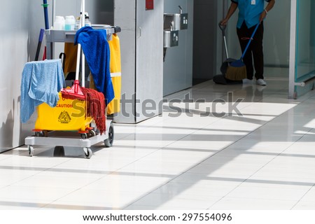 Mop bucket on cleaning in process and worker background