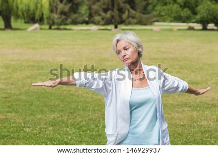 best ager women practicing yoga and tai chi outdoors