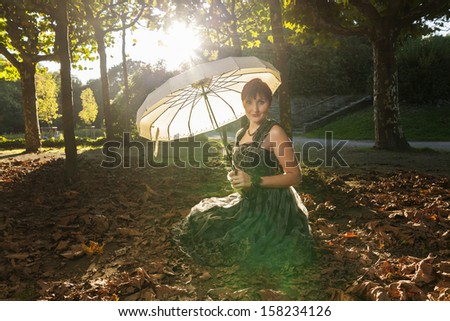 beautiful young women in vintage dress at fall, spring or autumn evening