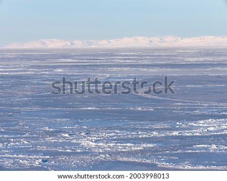 Frozen Disko Bay during winter, West Greenland, Disko Island in the background. Greenland, Denmark