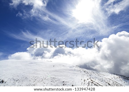 Cirrus and cumulus clouds over snowed mountains at the pyrenees/ Big cloud in the sky/ Pyrenees. Catalonia