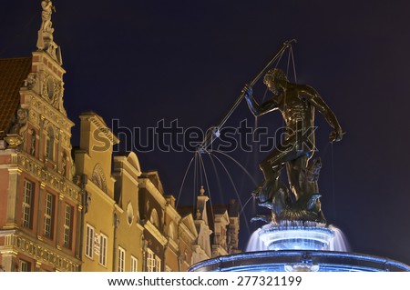 Statue of Neptune decorating the Old Square of Gdansk in Poland at night. Sightseeing and touristic attraction