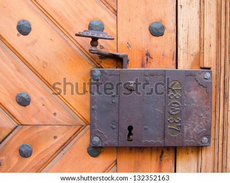 Ancient door lock from a medieval house. With date imprinted