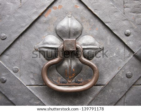 Detail of a medieval iron door with iron door handle