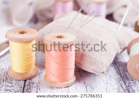 Set of reel of thread, needle and pins for sewing and needlework in the Shabby Chic style