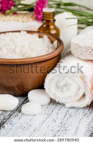 Spa salon with sea salt, towels and flowers.