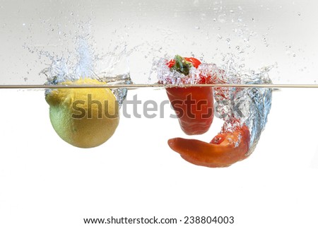 Half orange fall in water with big blue splash and razing blue light in a white background