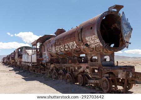 Old rusty locomotive with open steam boiler.Uyuni, train cemetery, Bolivia. Blue sky background