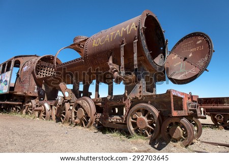 Old rusty locomotive with open steam boiler.Uyuni, train cemetery, Bolivia. Blue sky background
