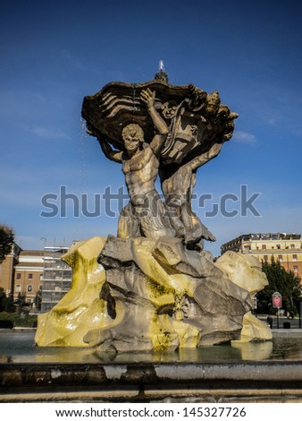 travertin male figures carrying a huge dish with water, antique fountain in rome, italy, europe