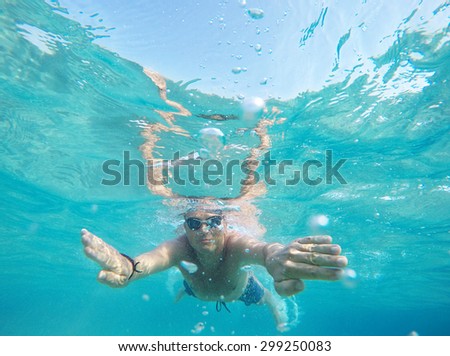 Swimming under the water in a clear sea