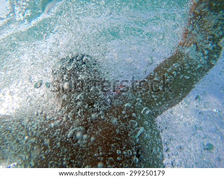 Swimming under water with a lot of bubbles